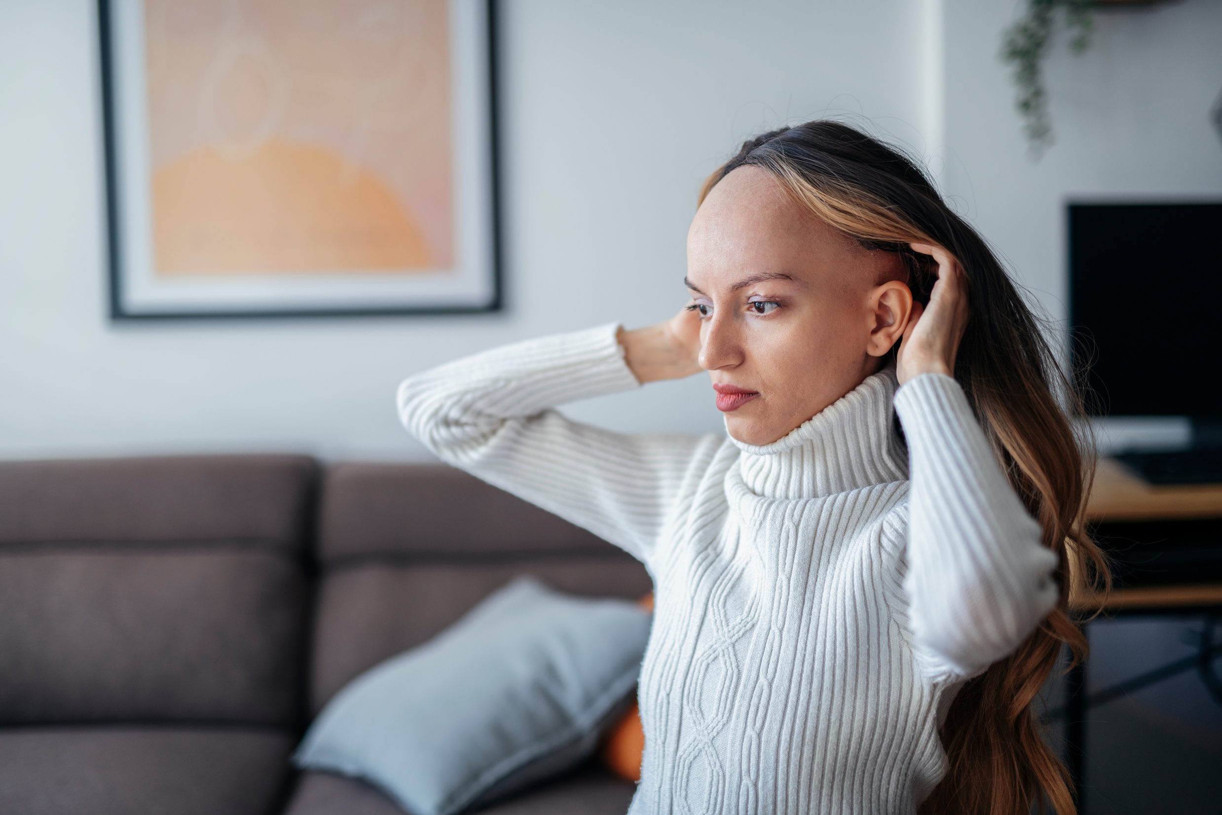 Woman with wig after hair loss due to cancer.